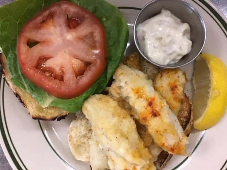 fish sandwich with lettuce, tomato and tartar sauce