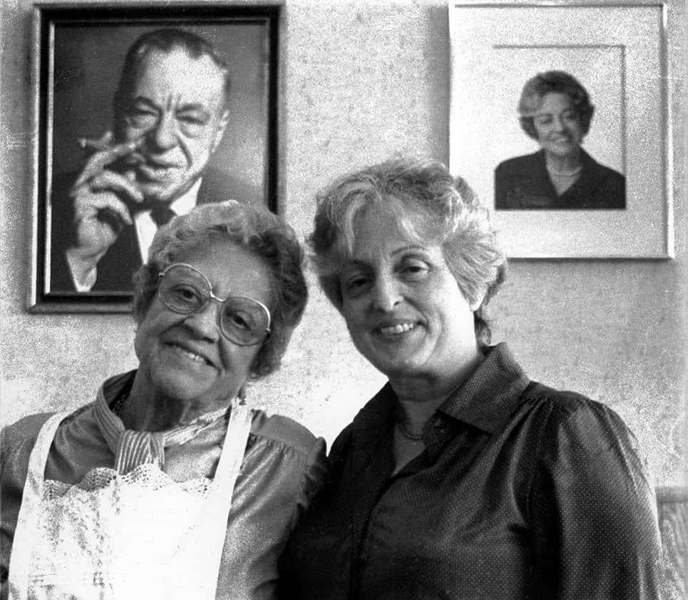 Clara with her mother Mama Celeste with Toto's photo in the background