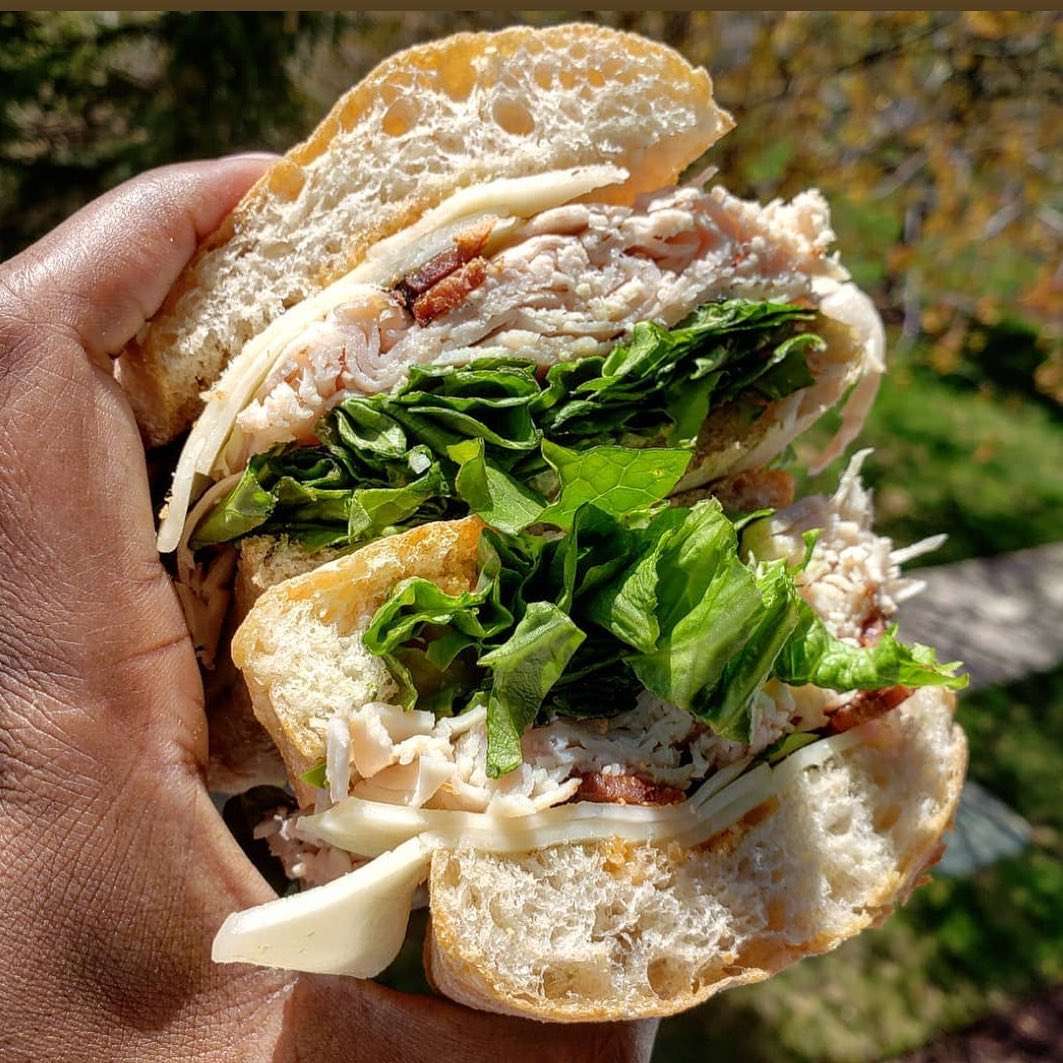 chicken sandwich with lettuce , bacon and cheese