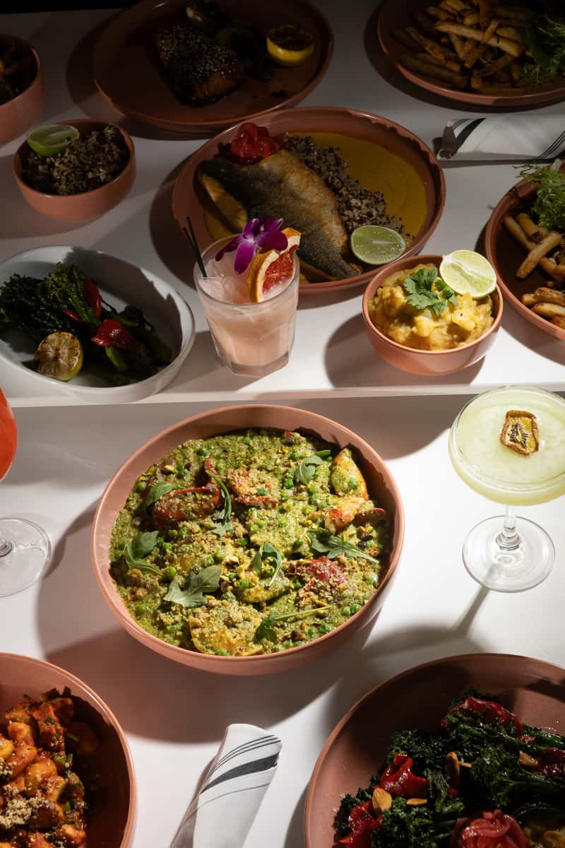 Seafood dishes and crafted cocktails arranged for a romantic anniversary dinner