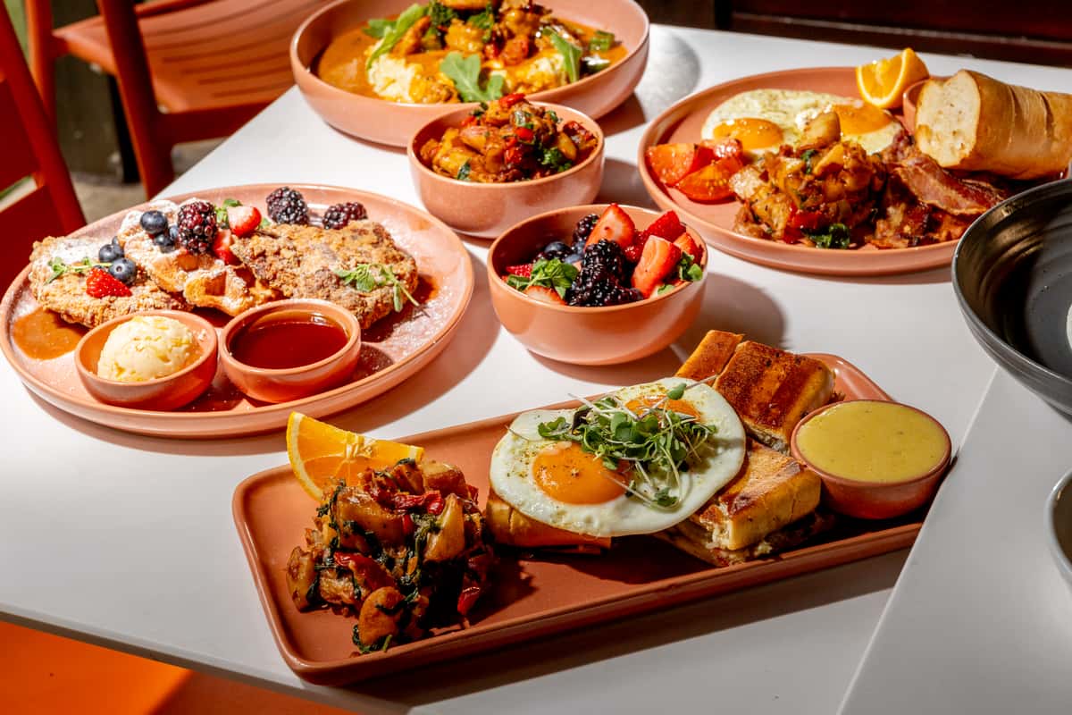 Glass & Vine brunch spread with eggs, breakfast potatoes, waffles, berries, and savory breakfast plates