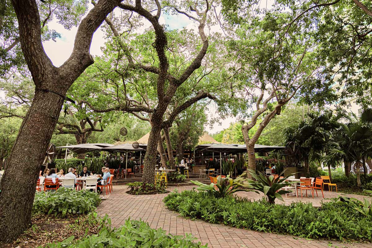 Outdoor Miami event venue with shaded garden seating area.