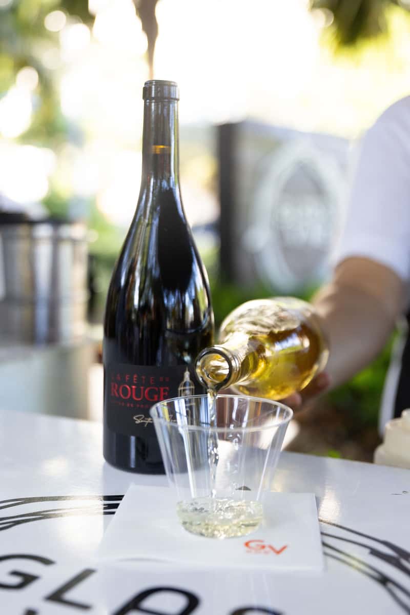 Wine being poured during an outdoor tropical venue event
