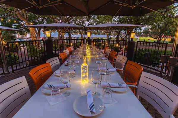Glass & Vine private dining setup showing elegant table arrangements under covered outdoor areas for special events