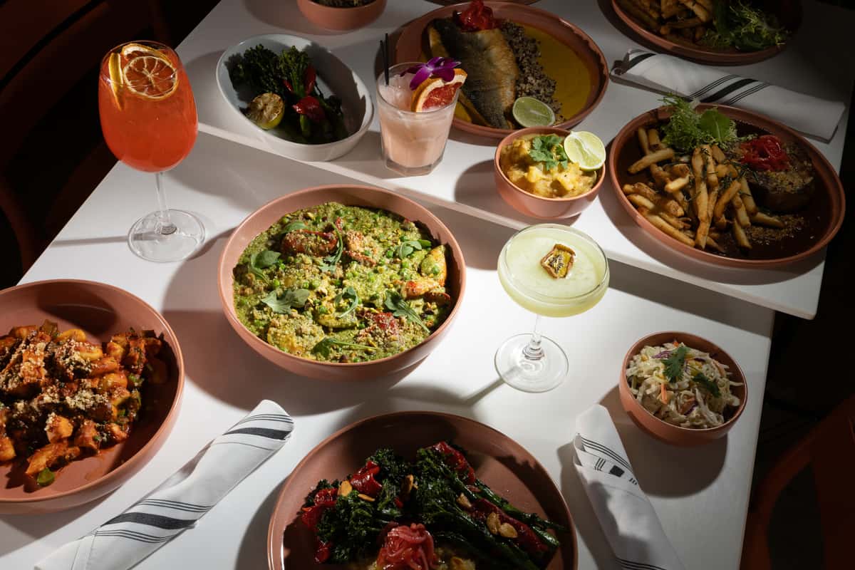 Romantic anniversary dinner spread with shared dishes and cocktails for couples.