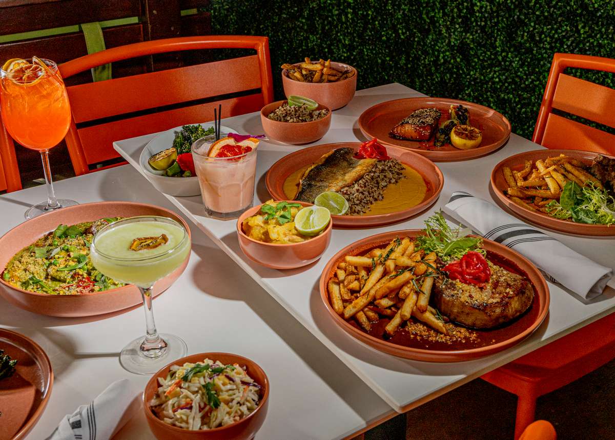 Glass & Vine table with shareable dishes and cocktails for a relaxed all-day dining experience