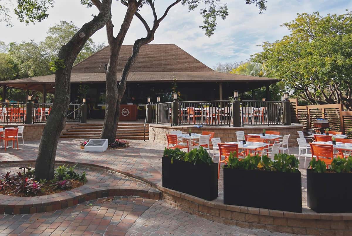 Glass & Vine's outdoor patio dining area with umbrellas and waterfront views
