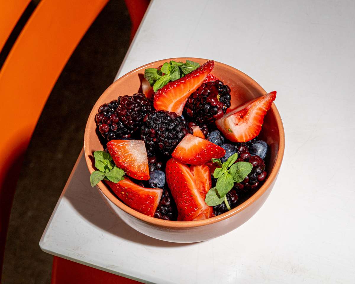 Fresh berry bowl with strawberries, blackberries, blueberries, and mint
