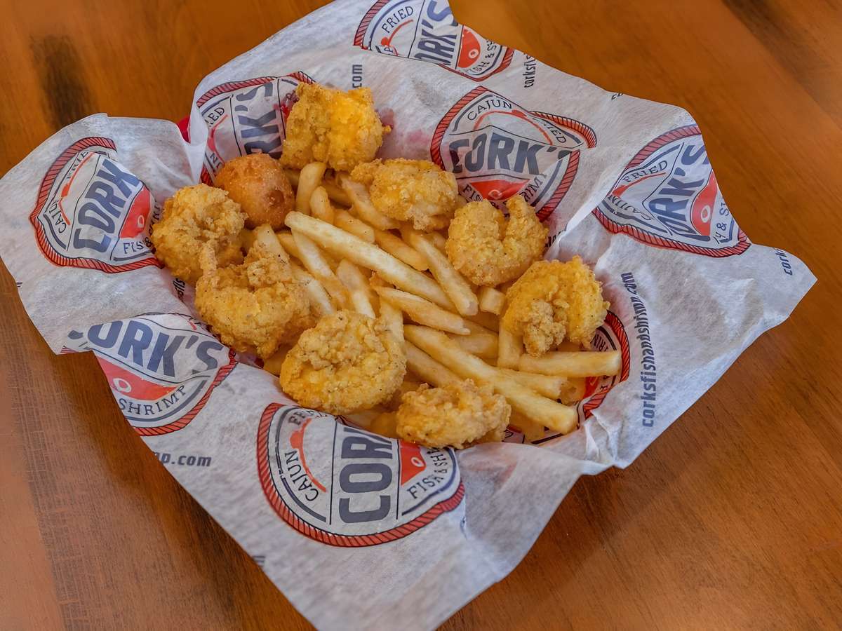Fried shrimp basket served with French fries and hush puppies.
