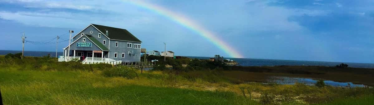 Sandbar & Grill exterior with rainbow