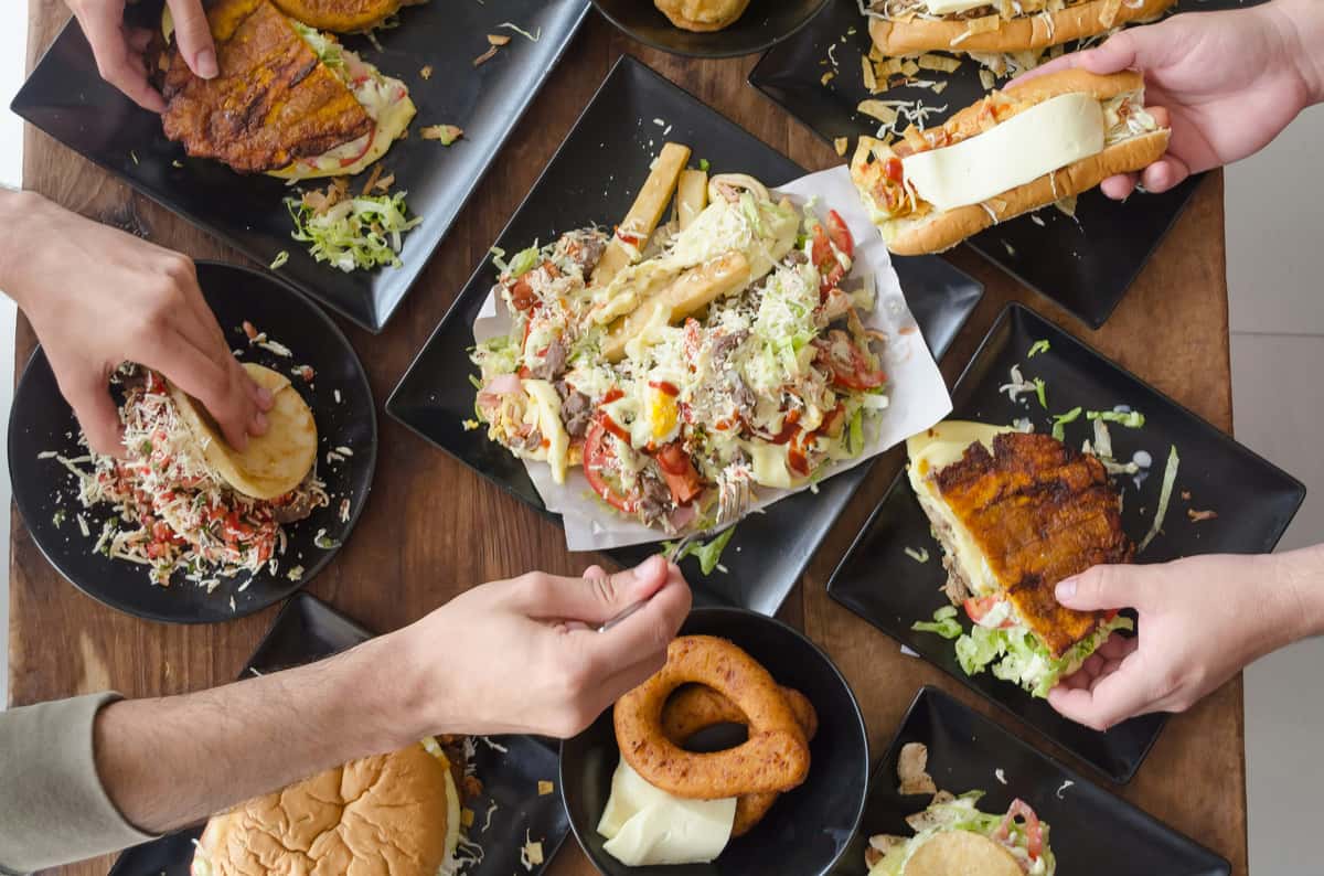 Friendly sharing of delicious food creating a strong sense of togetherness and fun