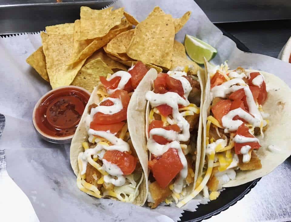 three soft tacos with tortilla chips