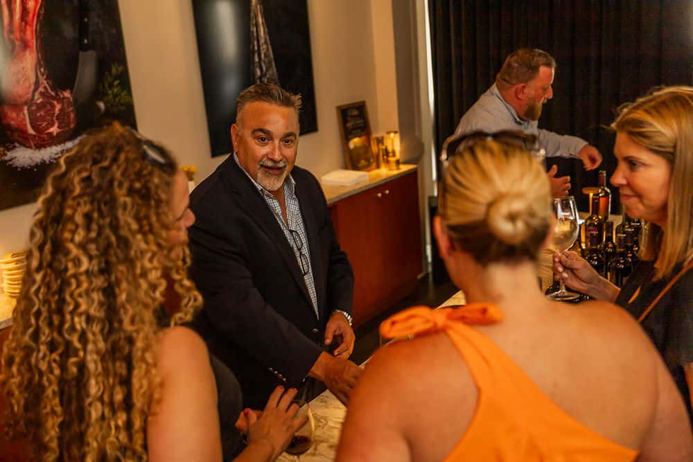 Guests socializing in smart casual attire at an upscale dining event.