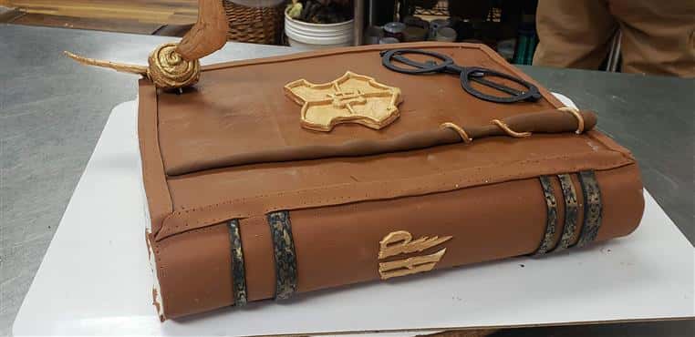 Harry Potter book cake with magic wand and eyeglasses