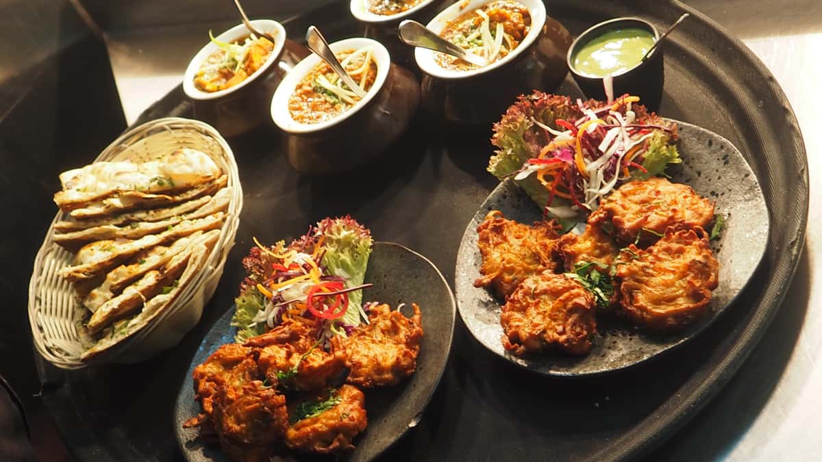 fried foods and side dishes with naan