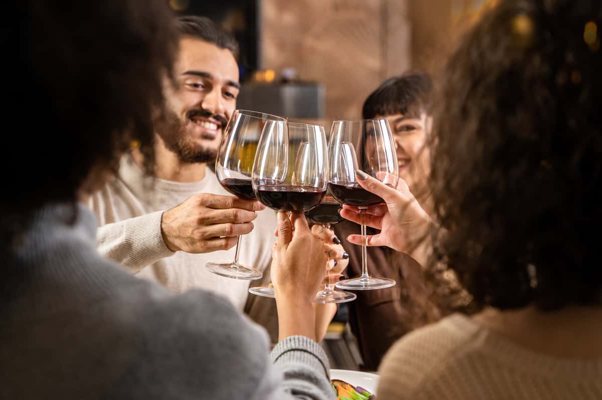 Friends toasting red wine