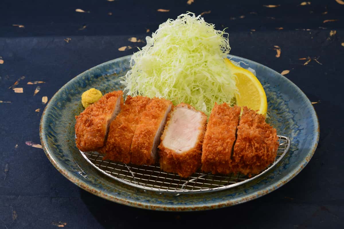 pork loin with a heaping bed of thinly sliced cabbage
