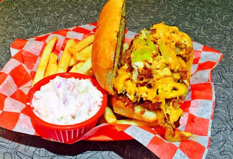 Sandwich with side of fries and cole slaw.