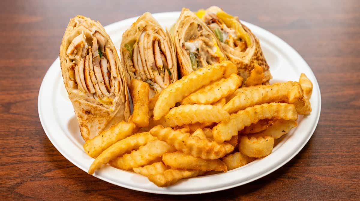 Chicken shawarma wraps with crinkle-cut fries on a white paper plate.