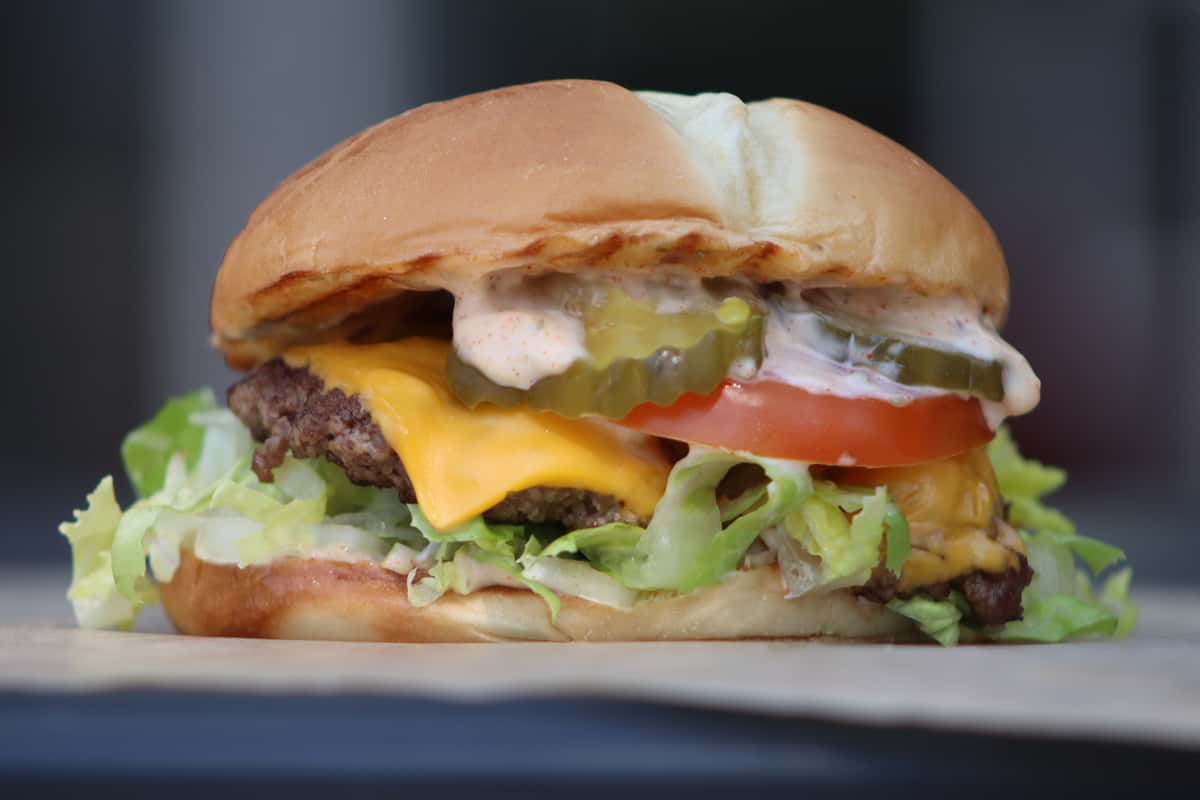 cheeseburger with pickles, tomato and lettuce