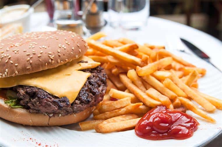 cheeseburger with fries and ketchup on the side
