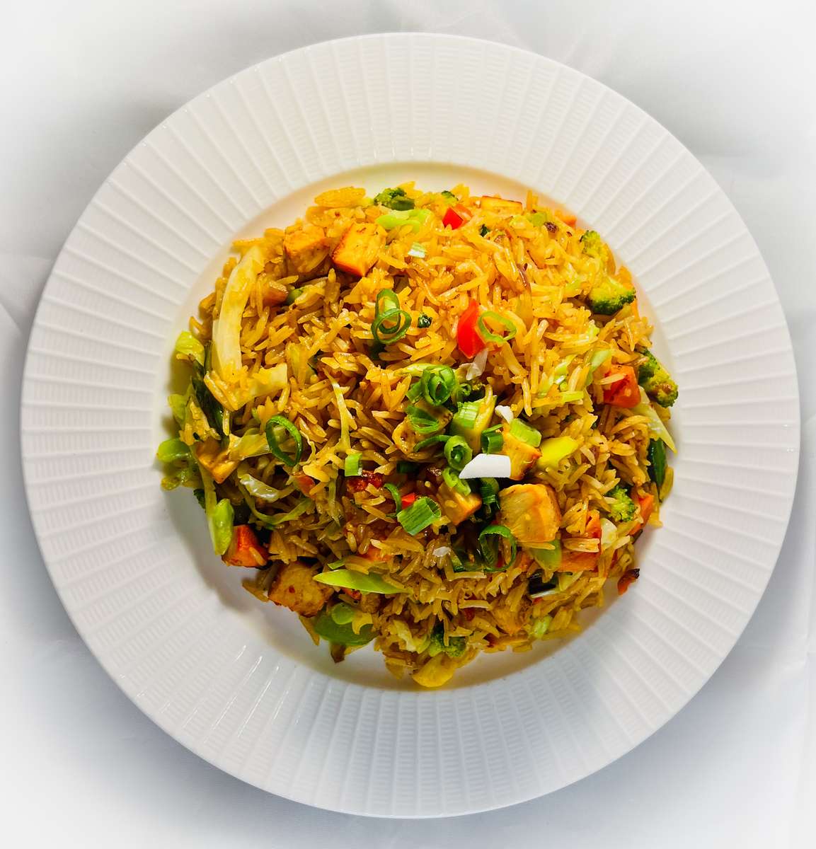 Basmati rice fried with chicken, seasonal vegetables, onion & garlic