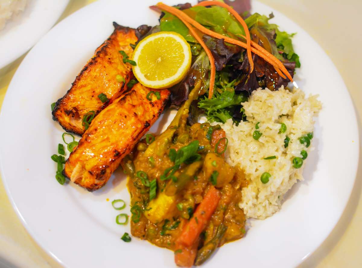 Seasoned & marinated wild salmon cooked in a clay oven. Served w/coconut peas rice & mixed vegetable curry