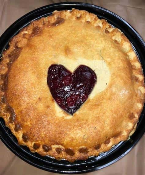 cherry pie with a heart shape cut out