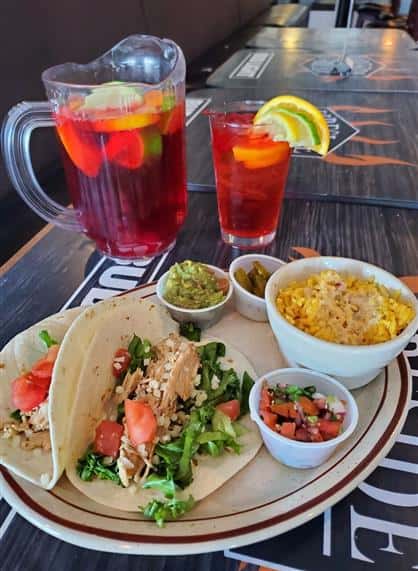 two chicken tacos and a pitcher of sangria