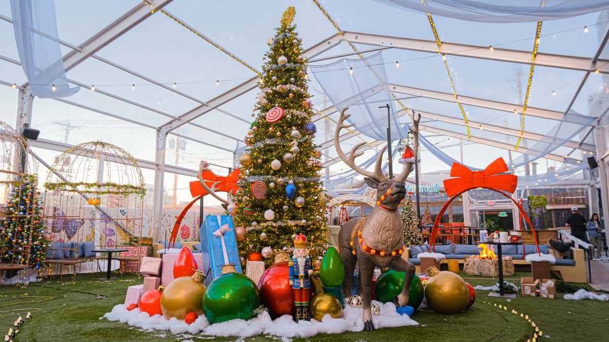 Covered outdoor pavilion decorated for seasonal celebrations with festive décor, lounge seating and event space designed for memorable private gatherings.
