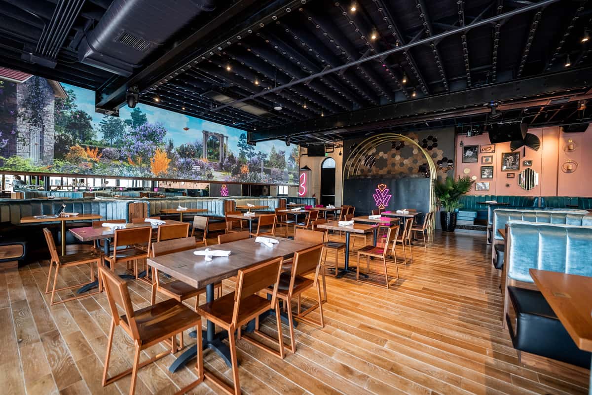 Spacious indoor dining area with flexible seating, large LED screens and modern décor, perfect for private parties, corporate events and celebrations.