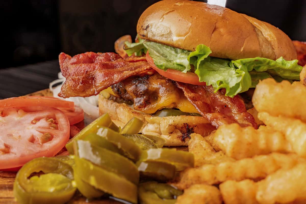 bacon cheeseburger with fries and toppings