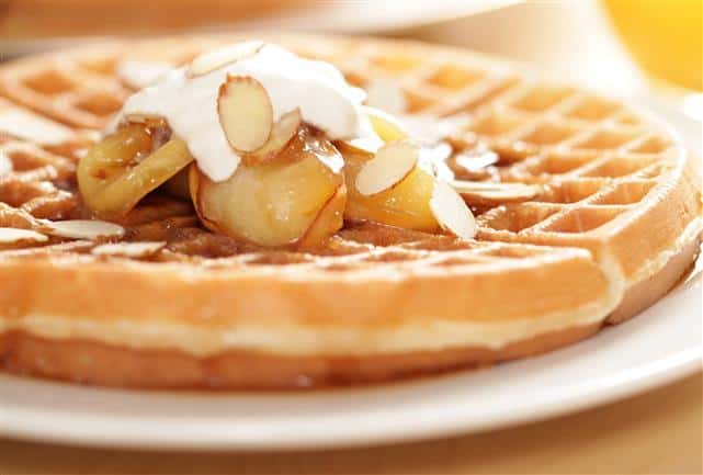 waffle topped with banana, syrup & almonds