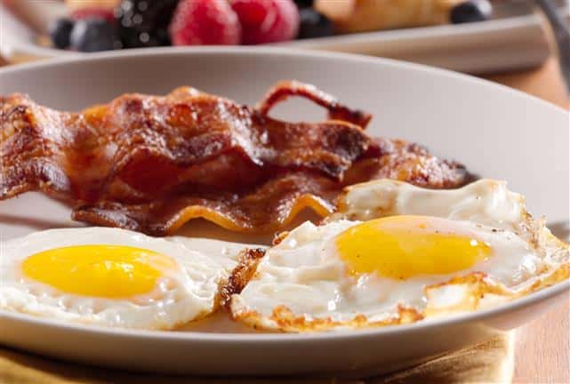 Two sunny-side up eggs with bacon