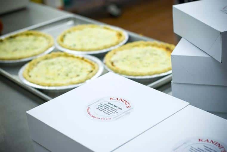 tray of baked quiches with Kanini's boxes