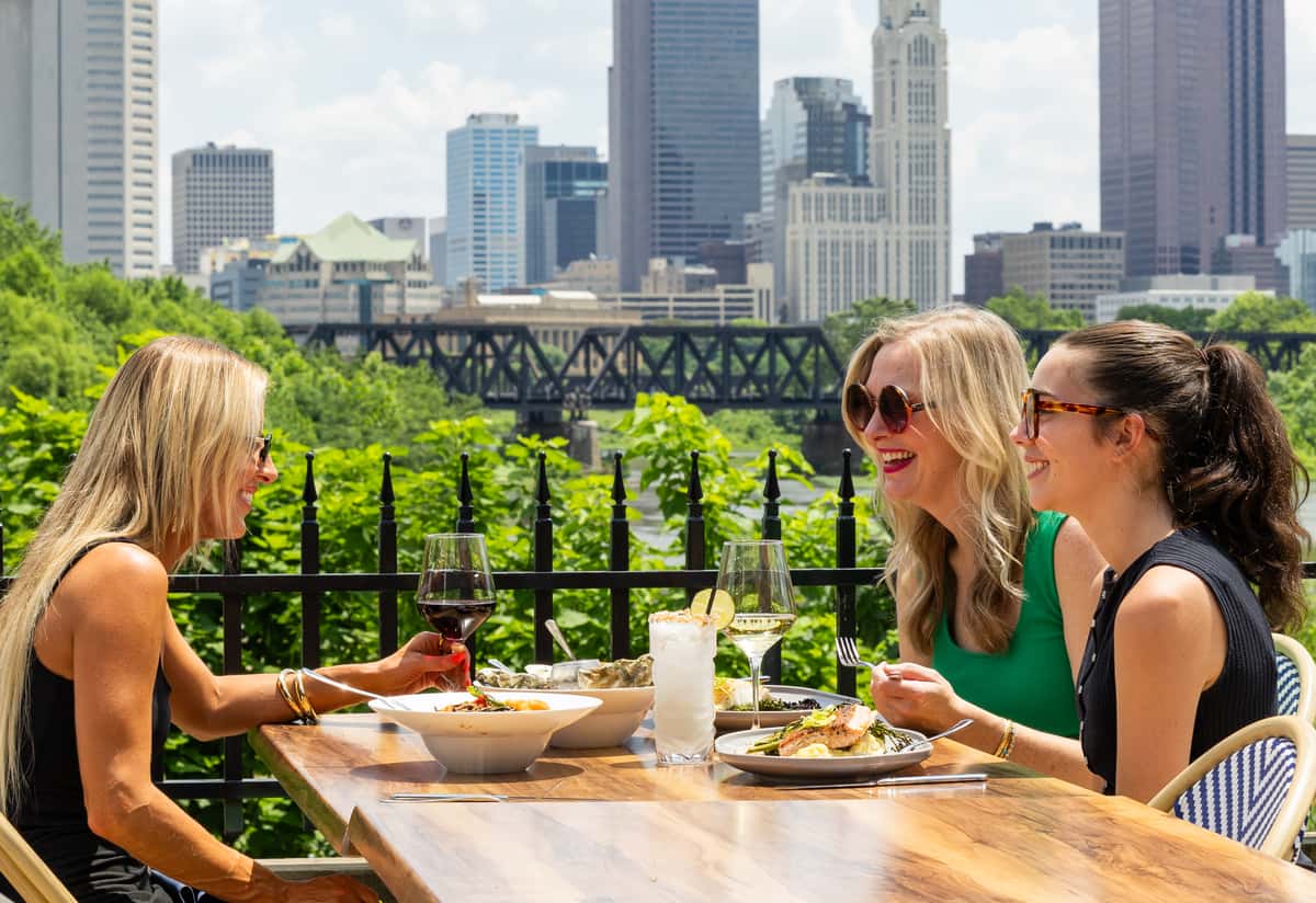 people sitting on a patio eating