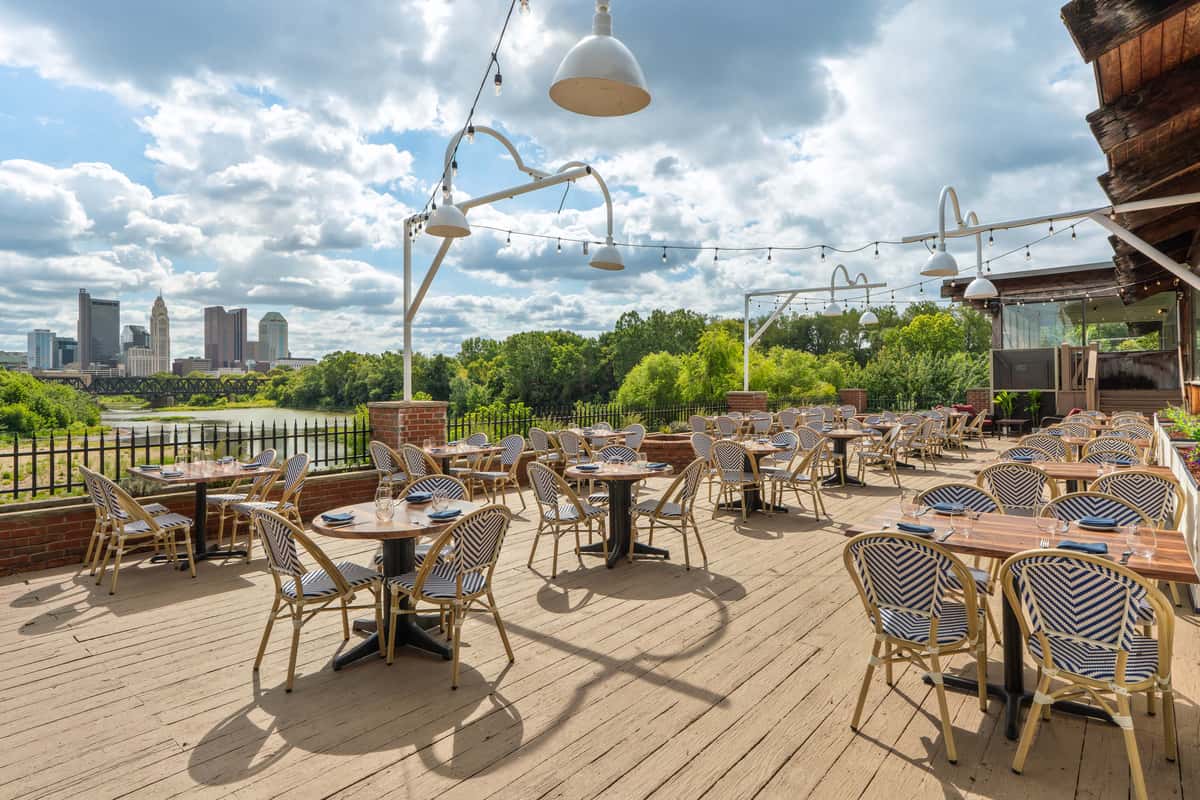 photo of chairs on a patio with a view of the skyline