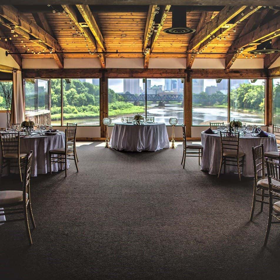 Private event venue space, Confluence, with floor to ceiling windows and wood beam ceilings