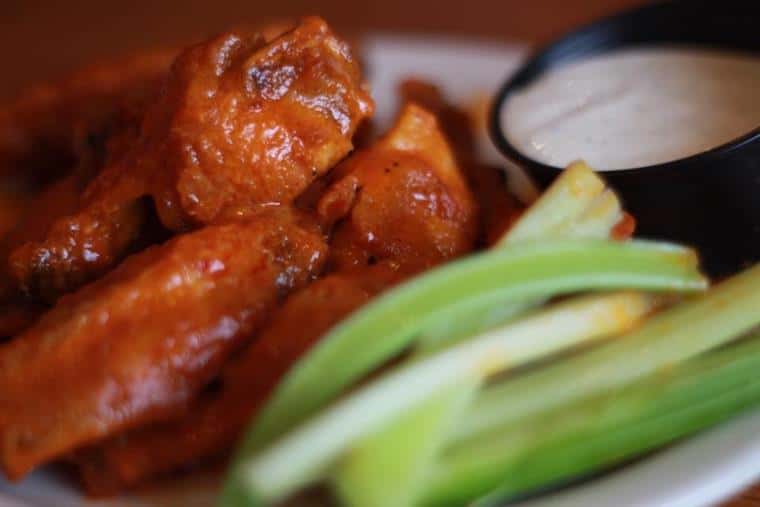 chicken wings tossed in buffalo sauce with celery sticks