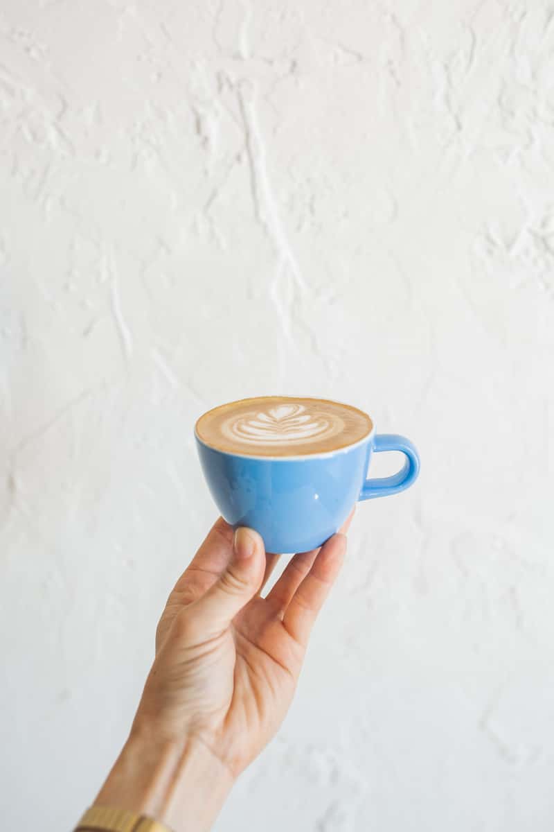 Blue mug of cappuccino