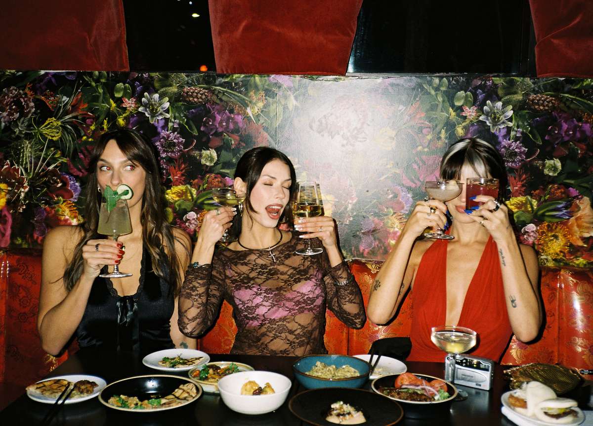 Customers celebrating restaurant visit with drinks