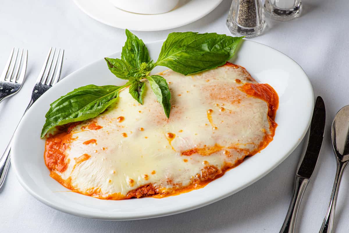 Chicken breast lightly breaded and pan-fried with tomato sauce and mozzarella served with penne