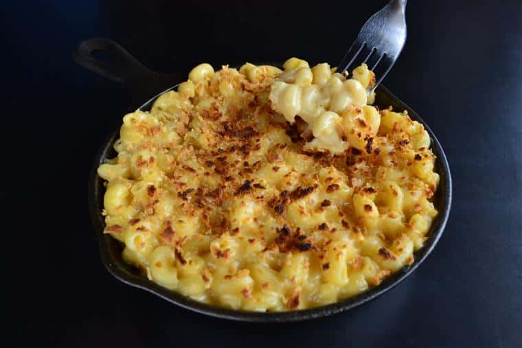 mac and cheee with fork taking a piece
