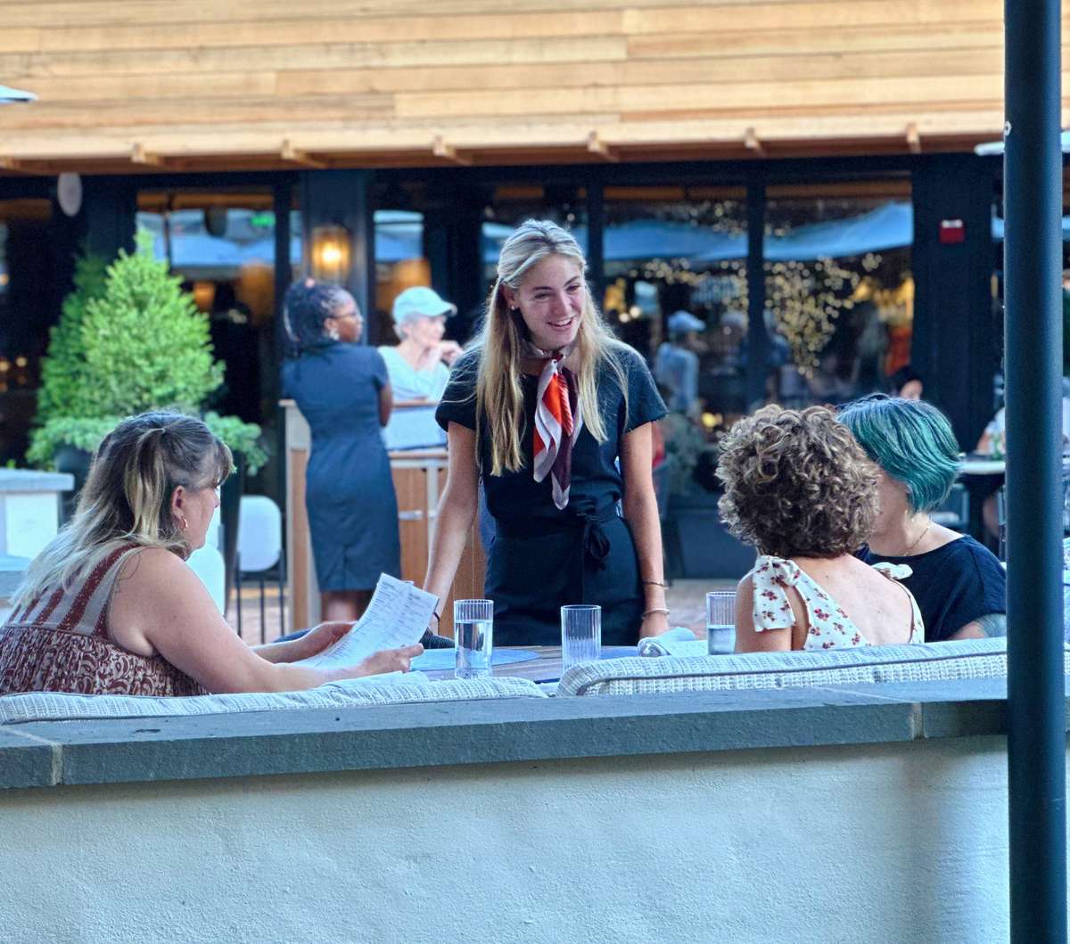 Server at Cece's greeting a table.