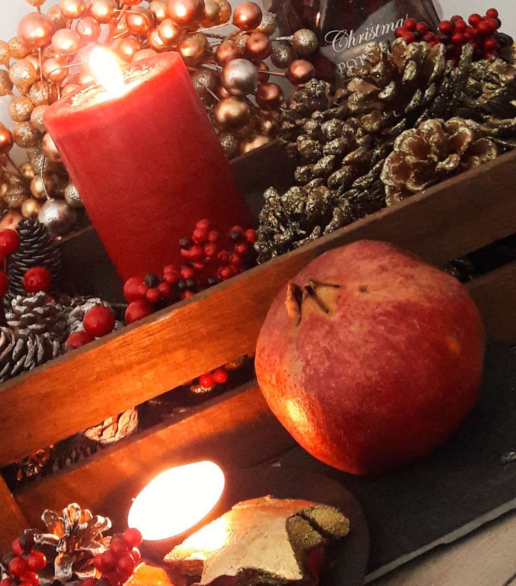 Christmas and New Year pomegranate, pinecones and candles decorations in Greece