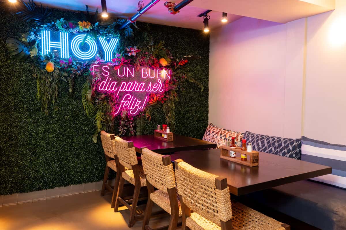 Interior space decorated with LED signs featuring wooden tables