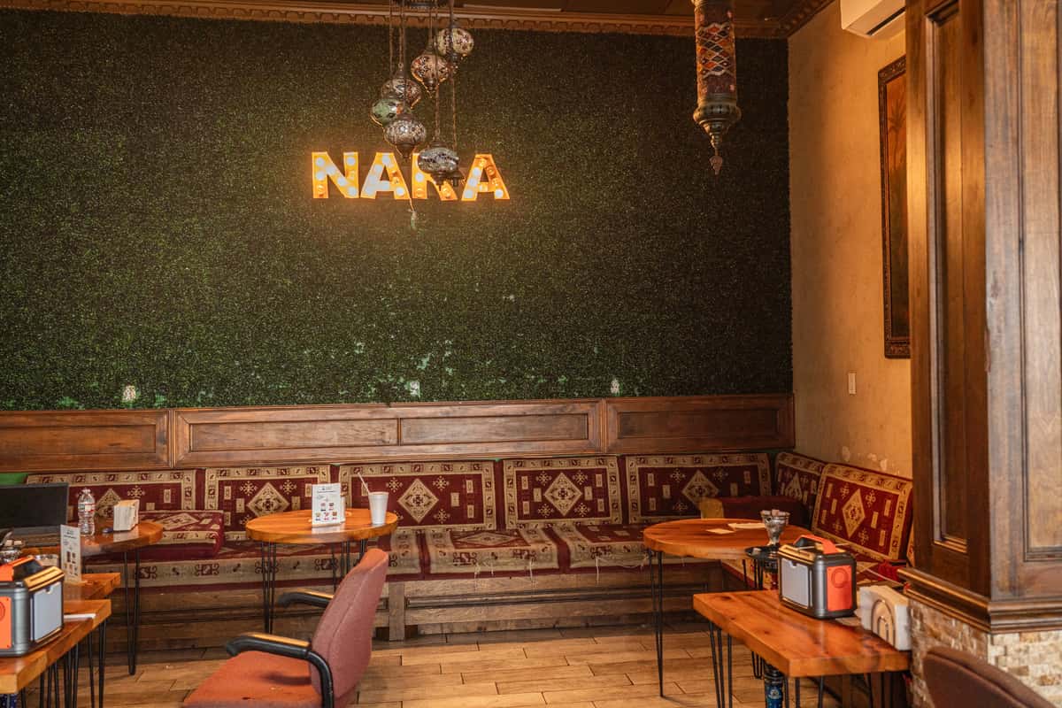 Warm interior seating and lounge atmosphere at Nara Cafe Middle Eastern restaurant in Houston.