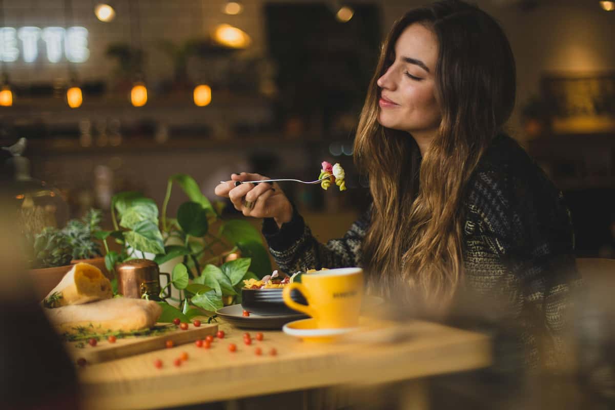 Girl having a happy meal of vegan pasta
