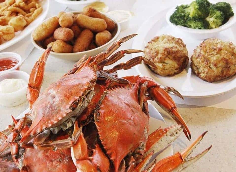 crabs with side dishes on table