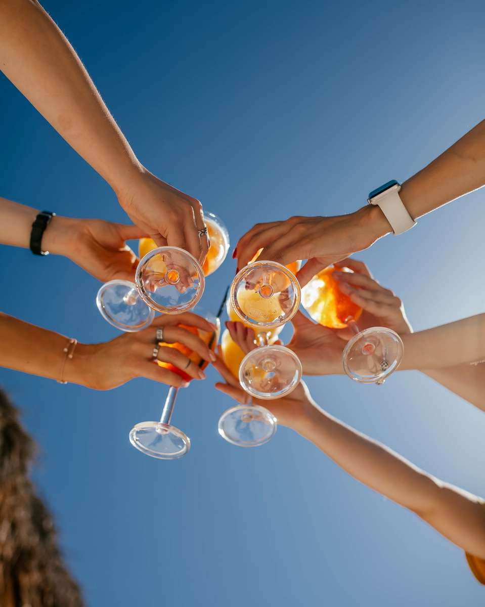 group holding cocktails